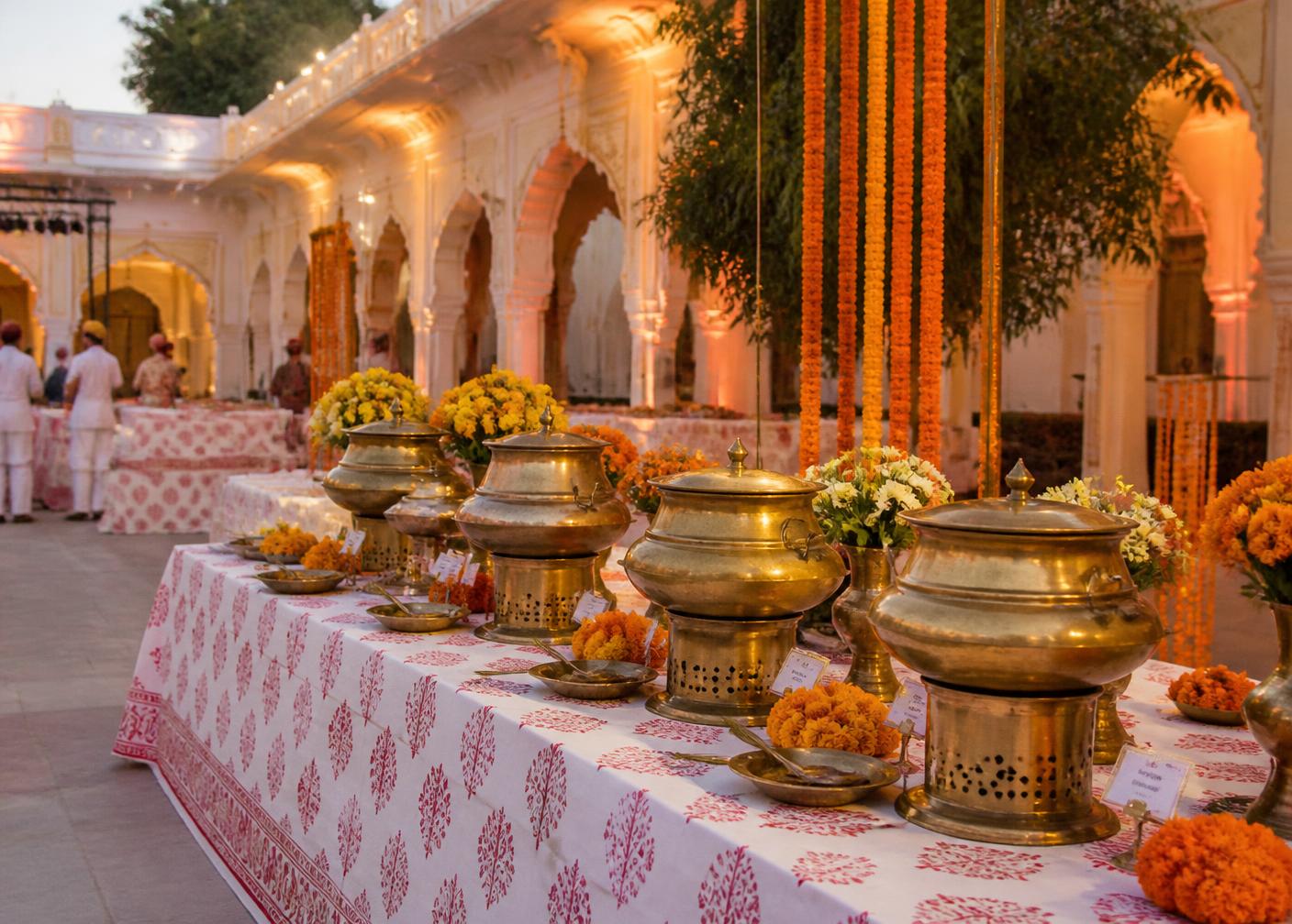 Rajasthani wedding catering buffet with brass vessels and marigold decorations